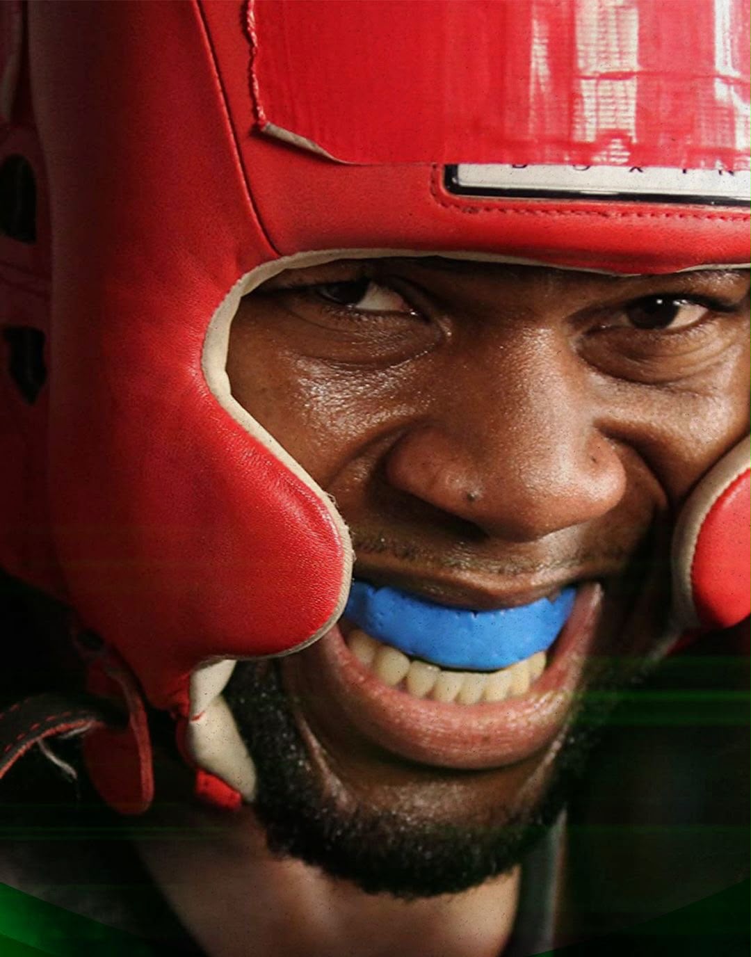 Atleta de boxe com protetor bucal azul e capacete vermelho, representando a proteção odontológica no esporte